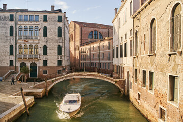 Venice, Italy - 10.12.2021: Traditional canal street with gondolas and boats in Venice, Italy.