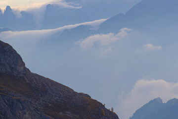 Fototapeta premium Clouds among the clifs and the rock of Dolomites mountains