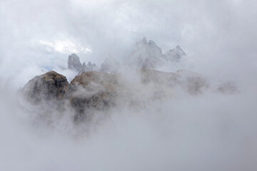 Summits and peaks appear through the clouds, from the Tre Cime path