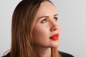 Fototapeta premium Close up womans face with plump lips with red matt lipsick. Beauty fashion portrait personal make up