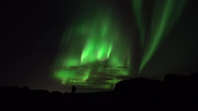 Partners embrace under aurora borealis real-time video