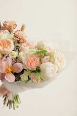 Colorful flowers assorted bouquet in bright paper. Holiday celebration concept. Bouquet of beautiful flowers in hands. Colorful flowers bouquet wrapped in paper