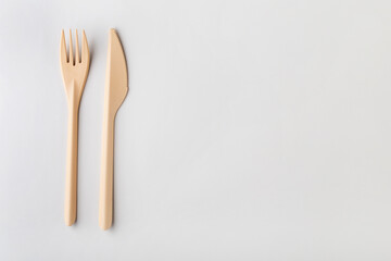 cutlery made of eco-friendly plastic on a gray solid background, top view