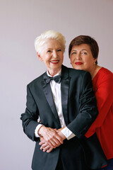 two stylish senior women hugging. love, friendship concept