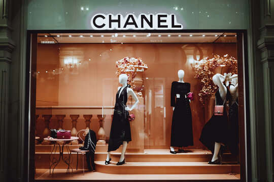 Female stylish mannequins in a shop window with Chanel bags. Chanel is a high fashion brand founded by Coco Chanel in 1909