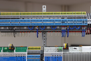 Multi-level pass-through terminals for connecting wires in an electrical panel.