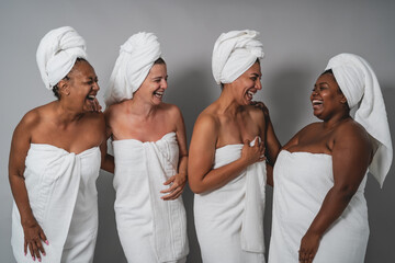 Happy women with different ages and body size having skin care spa day - People wellness and...