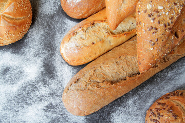 fresh bread, baguette and buns with seeds and spices.