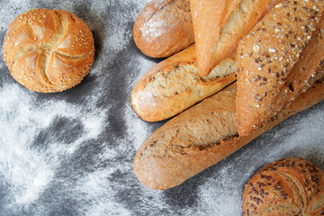 fresh bread, baguette and buns with seeds and spices.