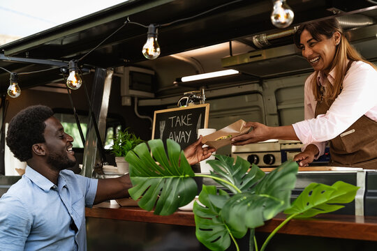 Young African Man Buying Meal From Food Truck - Modern Business And Take Away Concept