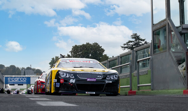 Nascar Racing Cars Group Aligned In Asphalt Track Pit Lane Copy Space On Top