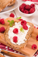 Rye bread with cottage cheese and raspberries.