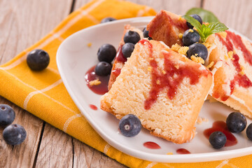 Lemon pund cake with blueberries and strawberry syrup.