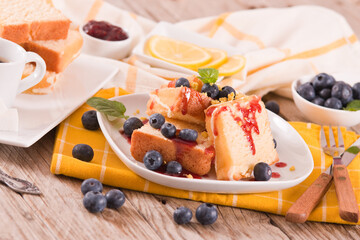 Lemon pund cake with blueberries and strawberry syrup.