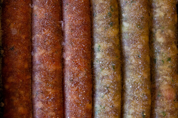 Raw frozen sausages kupaty, assorted. Background, top view.