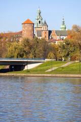 Wawel Royal Castle, view from the side of the Wisla river on an autumn day, Grunwaldzki Bridge over...