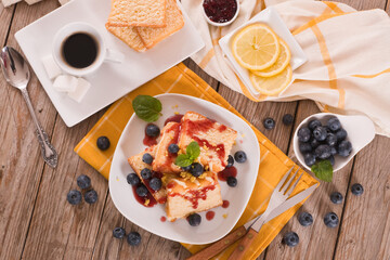 Lemon pund cake with blueberries and strawberry syrup.