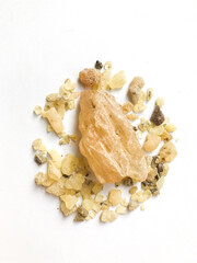 Natural resin of the jatoba tree in close-up on a white background. Beautiful background and place for text, yellow resin of the sacred tree