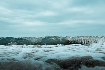 close up and detail of waves breaking on the shore