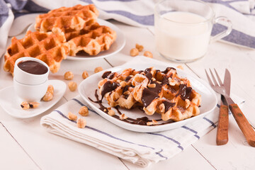 Waffles with chocolate cream and hazelnuts.