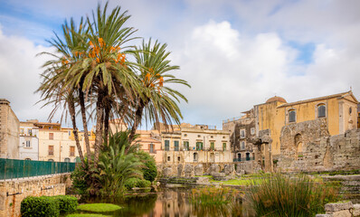 Fototapeta premium Daytime View of the Ruins of the Ancient Greek Temple of Apollo on Ortygia Island in Syracuse, Sicily, Italy - UNESCO World Heritage