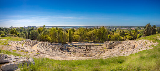 Panorama View of the Greek Theater il Teatro Greco at the Parco Archeologico della Neapolis, Viale Paradiso, Syracuse, Sicily, Italy - UNESCO World Heritage - obrazy, fototapety, plakaty