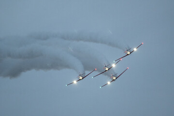 Group of flying aircraft against a cloudy sky during an airshow