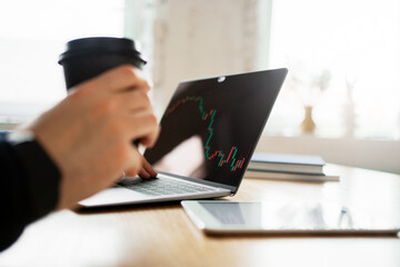 The company's financial report for the month. Working with documents and online spreadsheets. The man counts the company's revenue. Workplace in the office.