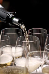 sparkling wine being served in a glass in tasting