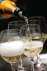 sparkling wine being served in a glass in tasting