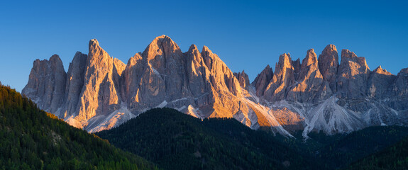 Fototapeta na wymiar Rocks during a bright sunset. Panoramic mountain scenery for background. Dolomite Alps, Italy. Large resolution photo.