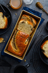 Banana bread or cake in a baking dish on a blue background. Cut pieces of bread in a plates. Fruit cake. Top view