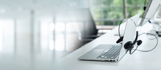 Headset and customer support equipment at call center ready for actively service . Corporate business help desk and telephone assistance concept .