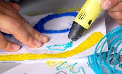 A persone drawing 3d pen that hardens in the air close-up.