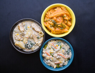 Different types of pasta in bowls