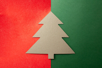 Fototapeta premium Cardboard tree on a red-green background without decorations.