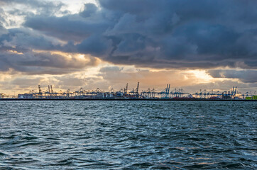 Hook of Holland, The Nethelrands, November 5, 2021: view across Nieuwe Waterweg canal towards the industry at Europoort under a dramatic sky