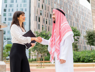 Diverse business partners shaking hands