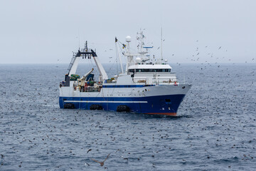 Fishing vessel floats in the sea.