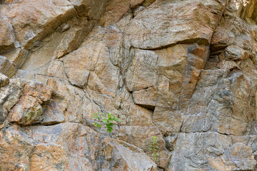 Destruction of the rock of the mountain after the explosion. Cracks in the granite rock due to human activity. Concept of environmental problems