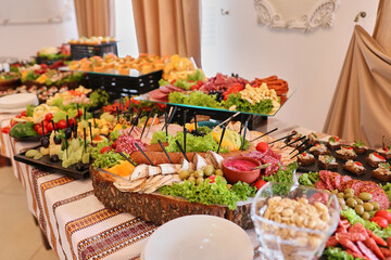 Obraz na płótnie Canvas Festive buffet table. Sandwiches with black and red caviar. Tomatoes with cheese and olives.