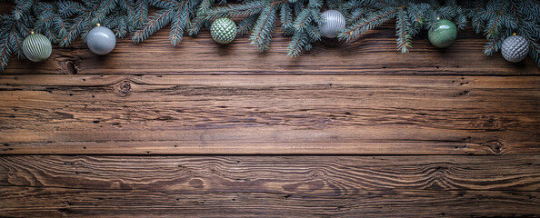 Cozy copy space background with spruce branches and Christmas tree ornaments on barn wood