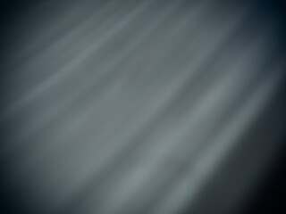 Diagonal rays of light on a gray background. Blurred abstract background light effect, light leaks....