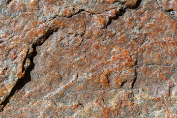Texture of granite rock. Cracked stone surface from weathering. Close up of granite surface. Earth color concept