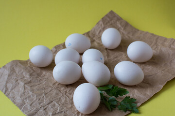 Chicken eggs on the yellow background