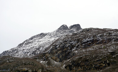 The top of a rocky mountain covered with snow