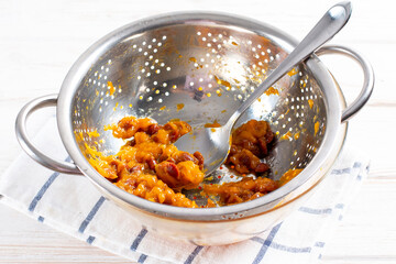 Yellow cherry plum in a colander on a table. Cherry plum for making tkemali sauce