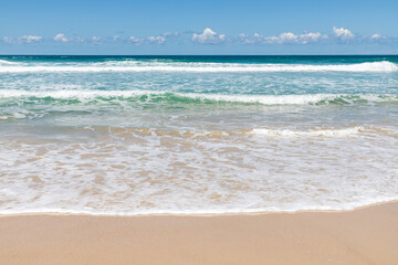 Fototapeta na wymiar Waves and sand on the beach