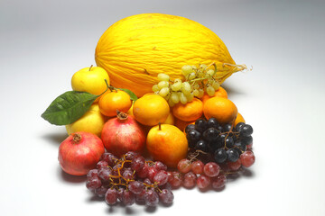 melon, apple, pear, pomegranate, grape and  tangerine isolated on white background. 