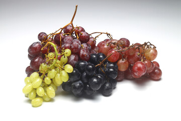 Bunch of Black and Red Grape with Green Seedless Grape isolated on white backgrounds.
